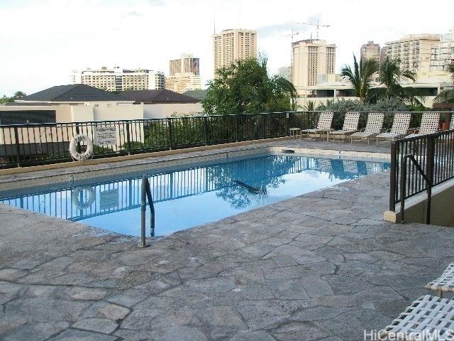 2140 Kuhio Ave Unit 801, Honolulu, HI 96815 - community pool featuring a fenced backyard, a patio area, and a view of city