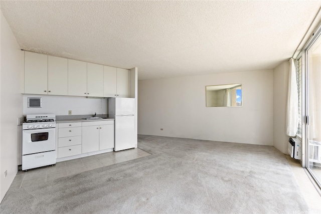 750 Amana St Unit 1111, Honolulu, HI 96814 - kitchen with visible vents, light colored carpet, a sink, white appliances, and white cabinetry