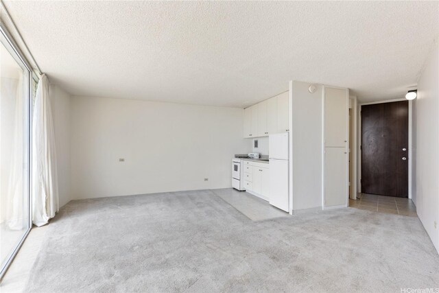 750 Amana St Unit 1111, Honolulu, HI 96814 - unfurnished living room featuring light carpet and a textured ceiling