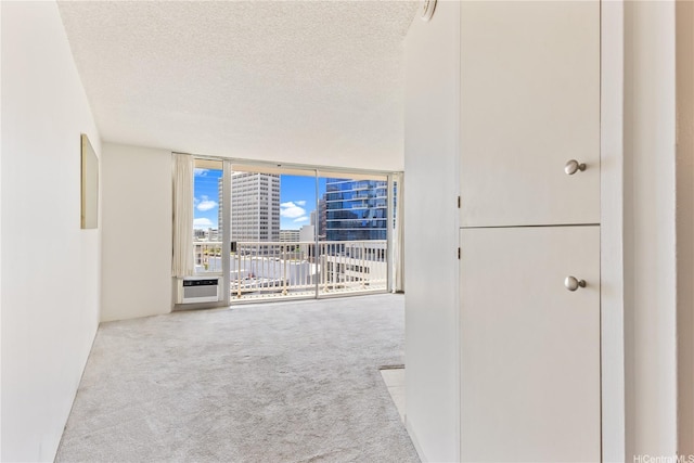750 Amana St Unit 1111, Honolulu, HI 96814 - interior space featuring a view of city, floor to ceiling windows, carpet, and a textured ceiling