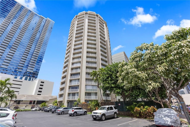 750 Amana St Unit 1111, Honolulu, HI 96814 - view of building exterior featuring uncovered parking and fence
