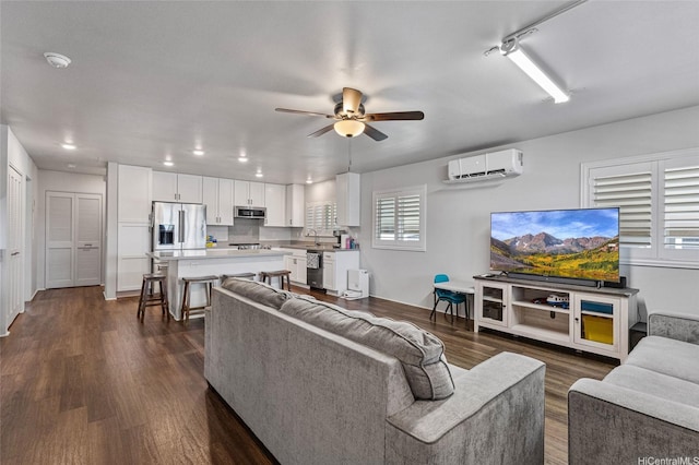 living room featuring a wall mounted air conditioner, dark wood finished floors, a ceiling fan, and recessed lighting