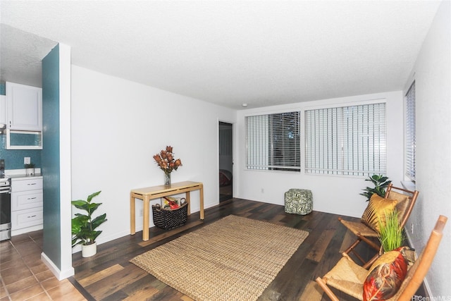 interior space featuring a textured ceiling, baseboards, and wood finished floors