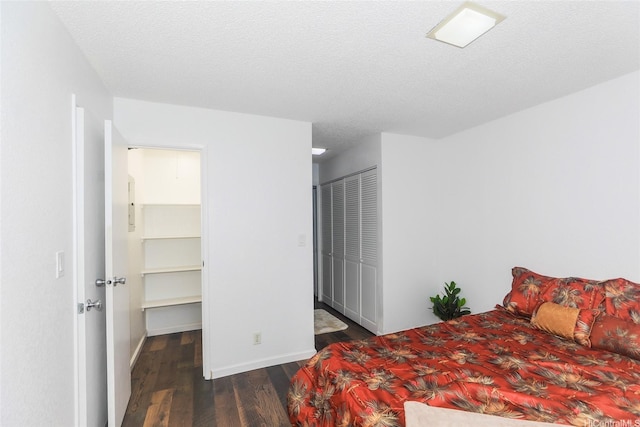 bedroom featuring wood finished floors, a closet, and baseboards
