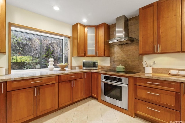 1623 Kalaniuka Way Unit 43, Honolulu, HI 96821 - kitchen with appliances with stainless steel finishes, wall chimney exhaust hood, brown cabinets, light stone countertops, and tasteful backsplash