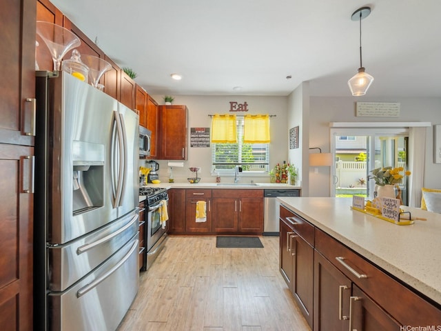 91-1483 Loiloi Loop, Ewa Beach, HI 96706 - kitchen featuring stainless steel appliances, a sink, light wood finished floors, decorative light fixtures, and recessed lighting