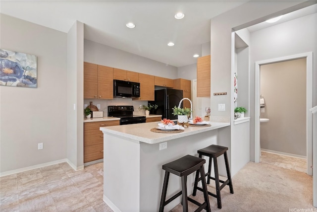 91-1159 Kamakana St Unit 829, Ewa Beach, HI 96706 - kitchen featuring black appliances, light countertops, a peninsula, a breakfast bar, and recessed lighting