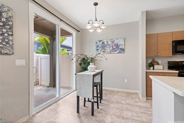 dining room with an inviting chandelier and baseboards