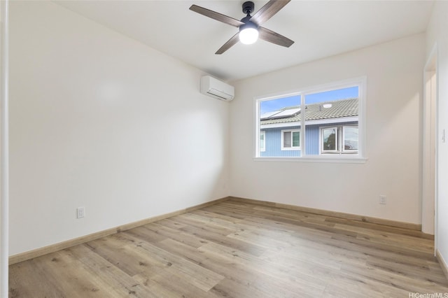 unfurnished room featuring a ceiling fan, baseboards, light wood-style floors, and a wall unit AC