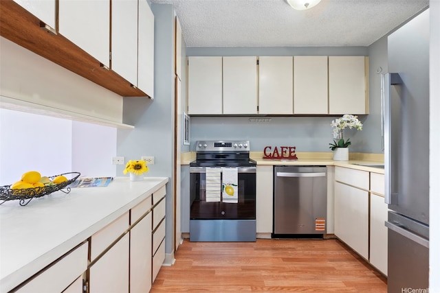 1031 Ala Napunani St Unit 401, Honolulu, HI 96818 - kitchen with open shelves, a textured ceiling, stainless steel appliances, light wood finished floors, and light countertops