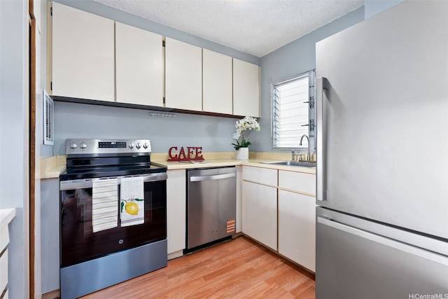 1031 Ala Napunani St Unit 401, Honolulu, HI 96818 - kitchen featuring light wood-type flooring, stainless steel appliances, light countertops, and a sink