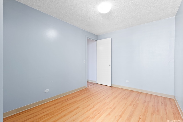 1031 Ala Napunani St Unit 401, Honolulu, HI 96818 - spare room featuring wood finished floors, a textured ceiling, and baseboards
