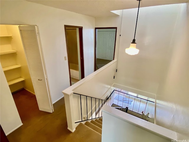 stairway featuring carpet, baseboards, and built in shelves