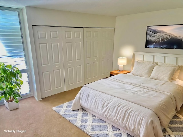 carpeted bedroom with a closet