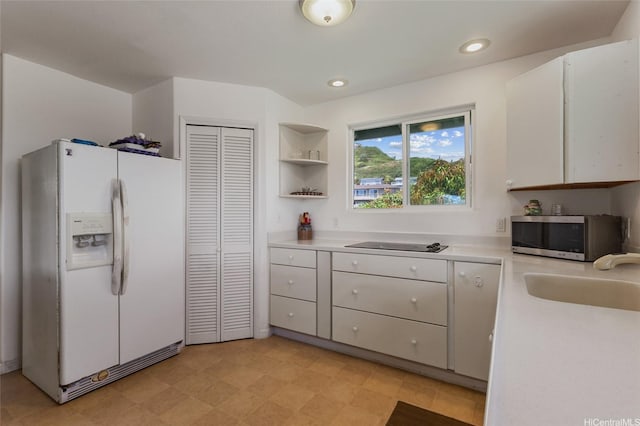 1315 Onioni St, Kailua, HI 96734 - kitchen with white refrigerator with ice dispenser, stainless steel microwave, light countertops, a sink, and recessed lighting