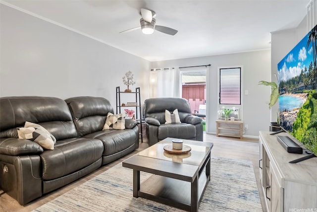 living room with baseboards, ceiling fan, and light wood-style flooring