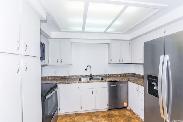 46-318 Haiku Rd Unit 70, Kaneohe, HI 96744 - kitchen with stainless steel appliances, dark countertops, and white cabinetry