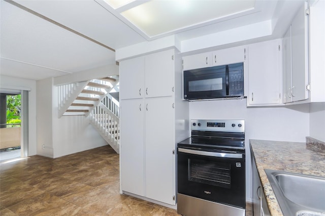 46-318 Haiku Rd Unit 70, Kaneohe, HI 96744 - kitchen with electric range, black microwave, white cabinets, and light countertops