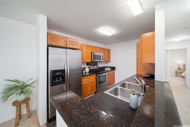 91-1039 Kamaaha Ave Unit 1505, Kapolei, HI 96707 - kitchen with stainless steel appliances, dark countertops, a peninsula, and brown cabinets