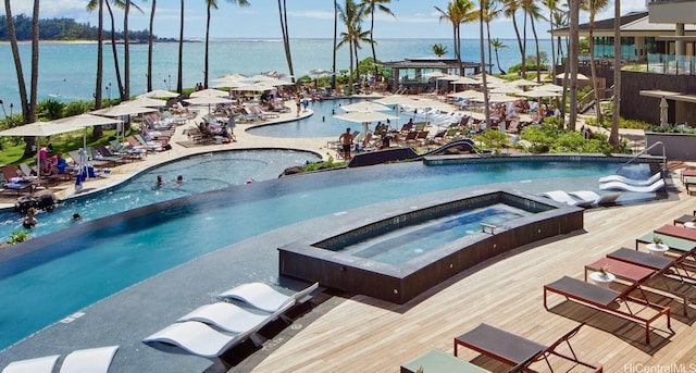 pool with a water view and a community hot tub