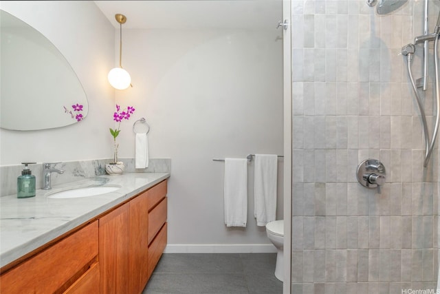 full bath with vanity, tile patterned flooring, toilet, and tiled shower