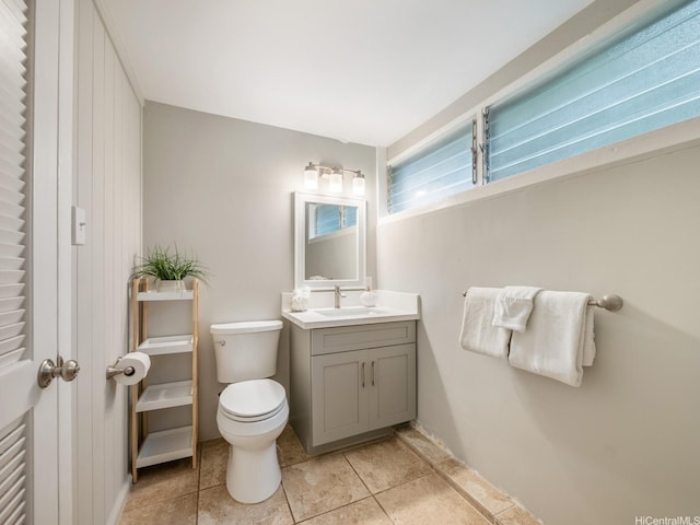 bathroom featuring toilet, vanity, and tile patterned flooring