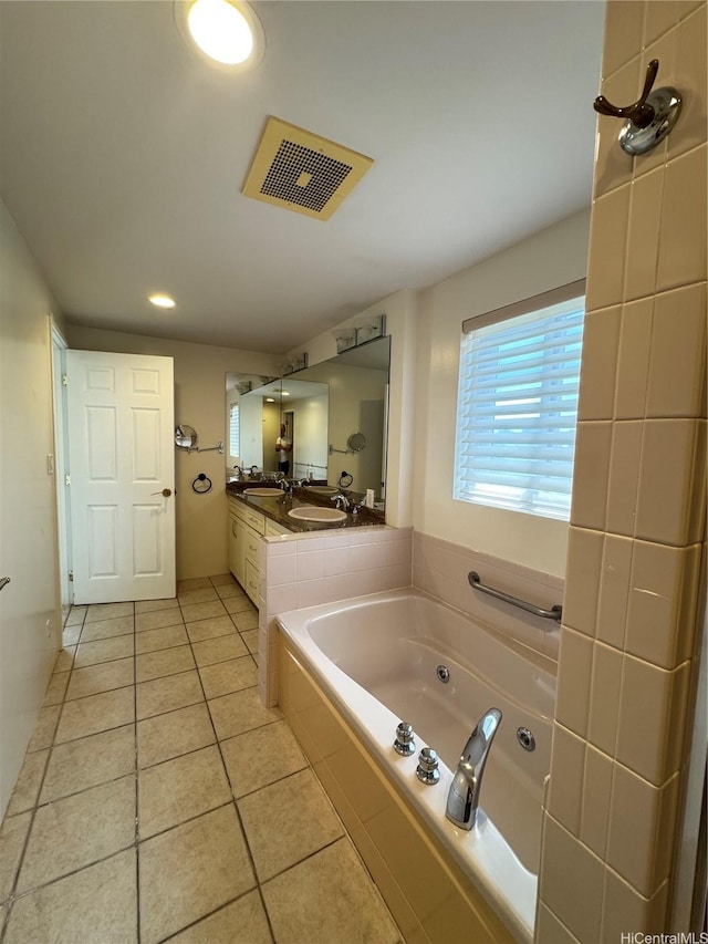 full bathroom featuring tile patterned floors, double vanity, visible vents, a sink, and a garden tub