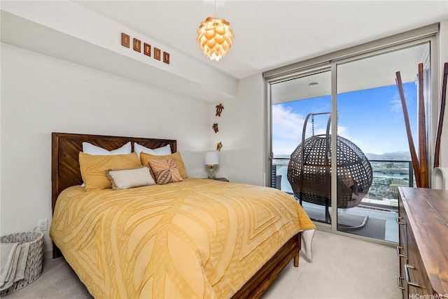 bedroom featuring access to exterior, floor to ceiling windows, and carpet floors