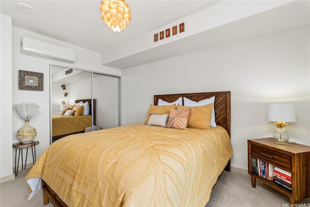 bedroom featuring a closet, a wall mounted air conditioner, baseboards, and carpet