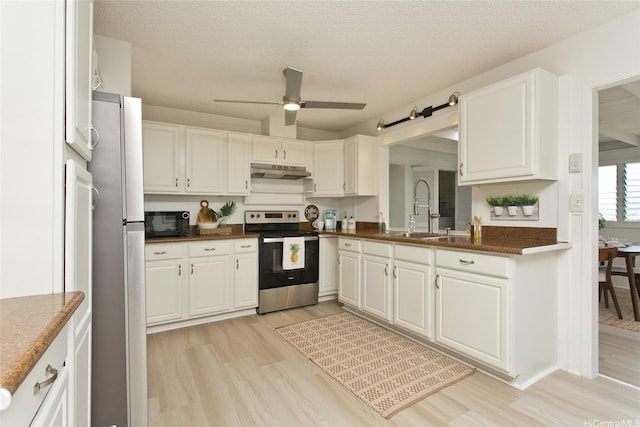 1334 Kuuna St, Kailua, HI 96734 - kitchen featuring appliances with stainless steel finishes, a sink, under cabinet range hood, dark countertops, and light wood-type flooring