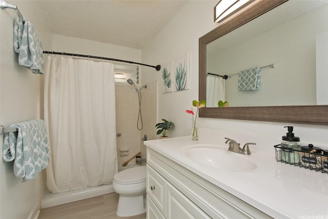 1334 Kuuna St, Kailua, HI 96734 - bathroom featuring vanity, toilet, wood finished floors, a textured ceiling, and shower / bath combination with curtain