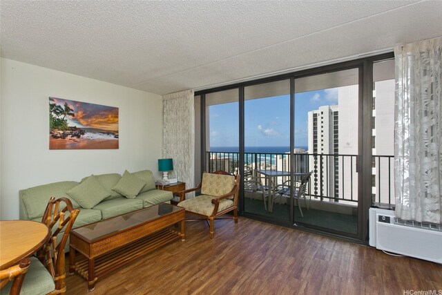 201 Ohua Ave Unit 3006, Honolulu, HI 96815 - living room with a water view, a textured ceiling, a wall of windows, and wood finished floors