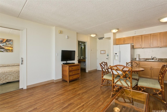 201 Ohua Ave Unit 3006, Honolulu, HI 96815 - dining area featuring baseboards, a textured ceiling, and wood finished floors