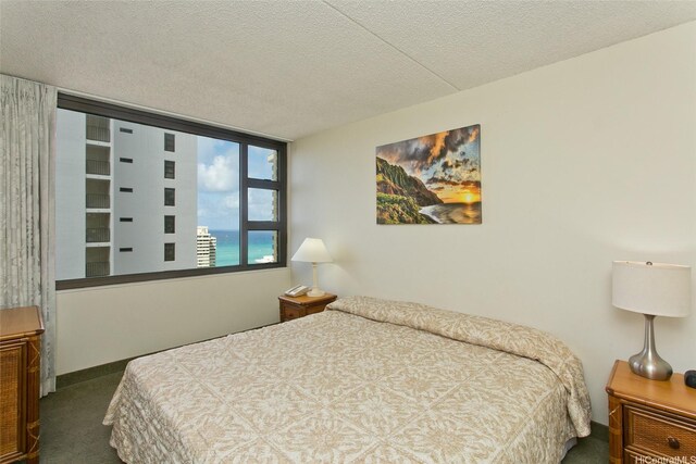 201 Ohua Ave Unit 3006, Honolulu, HI 96815 - bedroom with dark carpet and a textured ceiling