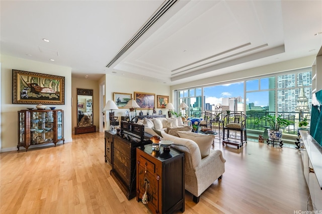 1740 S Beretania St Unit 9, Honolulu, HI 96826 - living area featuring a raised ceiling, light wood-style floors, a city view, and recessed lighting