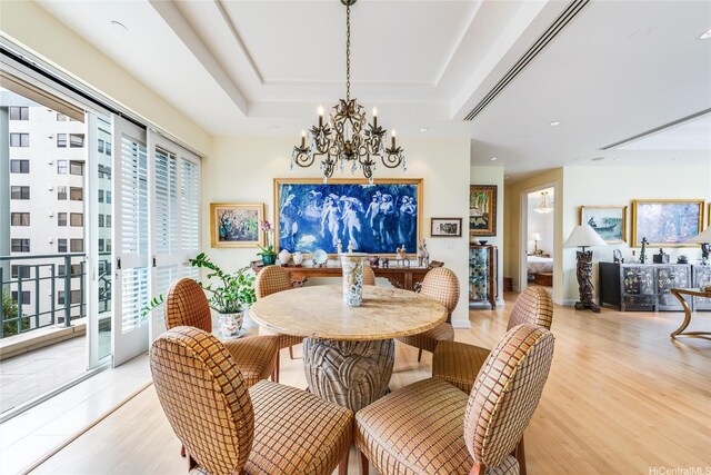 1740 S Beretania St Unit 9, Honolulu, HI 96826 - dining area featuring a chandelier, light wood finished floors, a tray ceiling, and recessed lighting