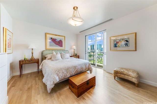 1740 S Beretania St Unit 9, Honolulu, HI 96826 - bedroom with access to outside, light wood-style floors, and baseboards