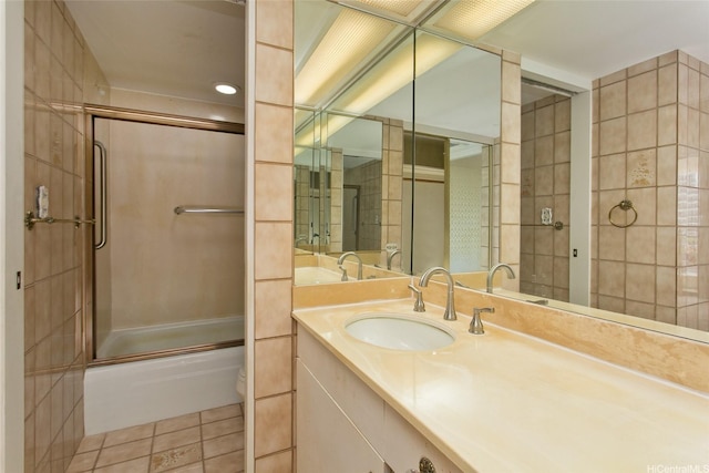full bath featuring tile patterned flooring, toilet, combined bath / shower with glass door, and vanity