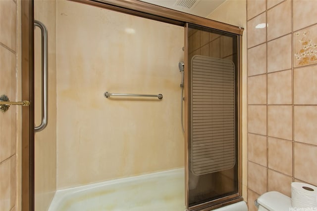 full bathroom with toilet, visible vents, and a stall shower