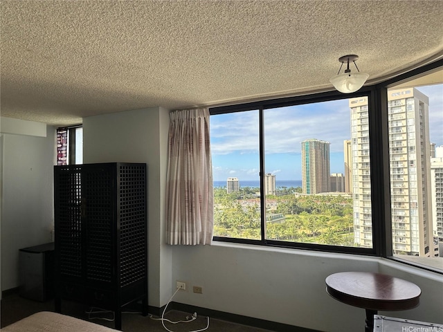 bedroom featuring a view of city and a textured ceiling