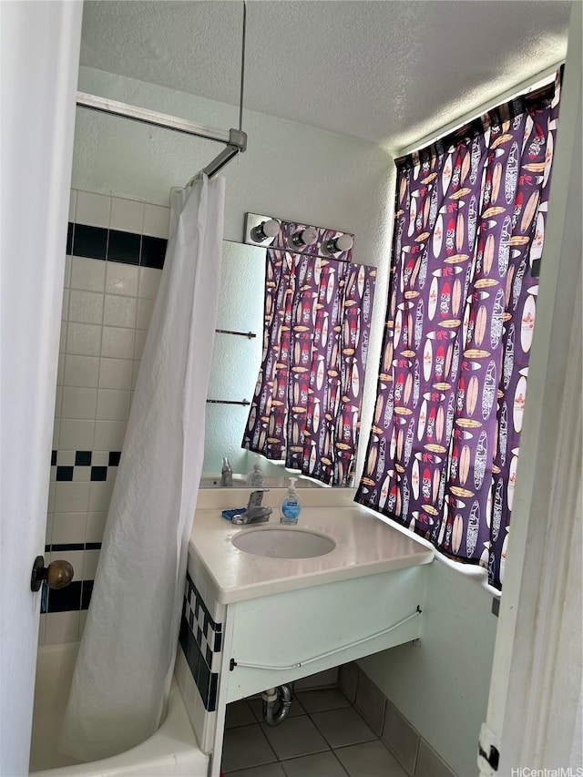 full bath featuring vanity, shower / bathtub combination with curtain, tile patterned flooring, and a textured ceiling