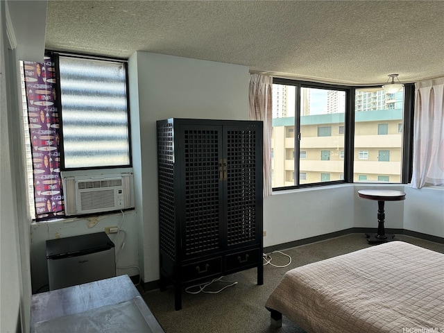 carpeted bedroom with baseboards, cooling unit, and a textured ceiling