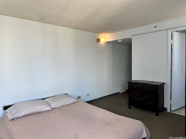 carpeted bedroom with a textured ceiling