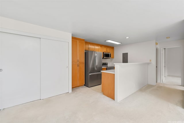 7188 Hawaii Kai Dr Unit 244, Honolulu, HI 96825 - kitchen with electric panel, a peninsula, light colored carpet, light countertops, and appliances with stainless steel finishes