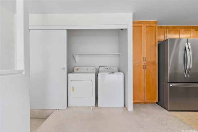 7188 Hawaii Kai Dr Unit 244, Honolulu, HI 96825 - laundry room with washing machine and dryer, light carpet, and laundry area