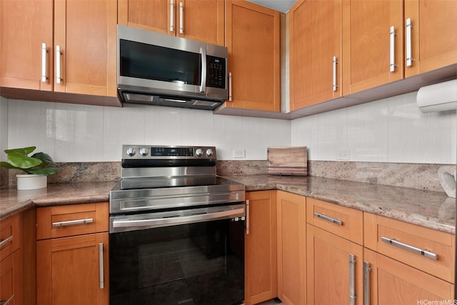 2920 Ala Ilima St Unit 1003, Honolulu, HI 96818 - kitchen with appliances with stainless steel finishes, light stone countertops, and a wall mounted AC