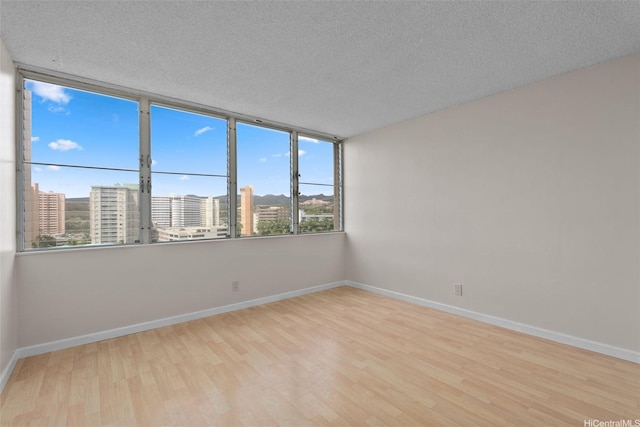 2920 Ala Ilima St Unit 1003, Honolulu, HI 96818 - spare room with wood finished floors, baseboards, and a textured ceiling