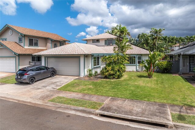 view of front facade with concrete driveway, a front lawn, roof with shingles, and a garage