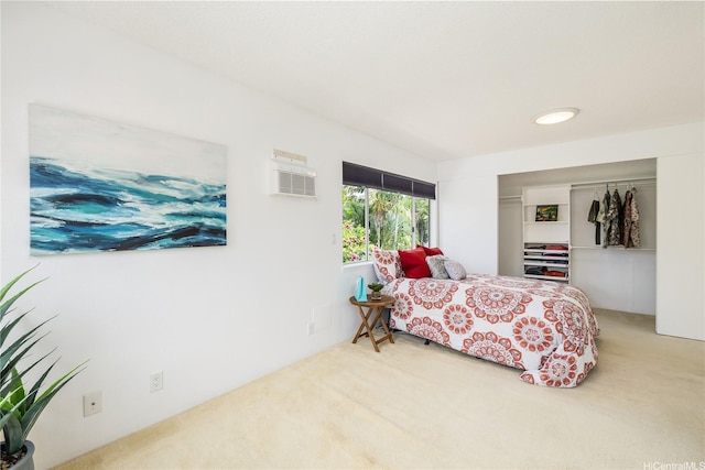 carpeted bedroom with a closet and a wall mounted AC