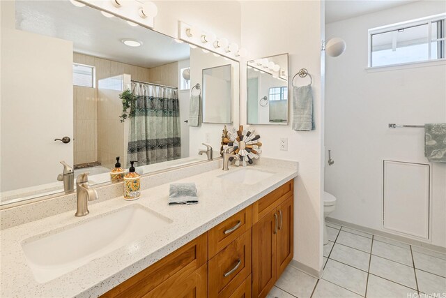 full bathroom with plenty of natural light, a sink, and tile patterned flooring